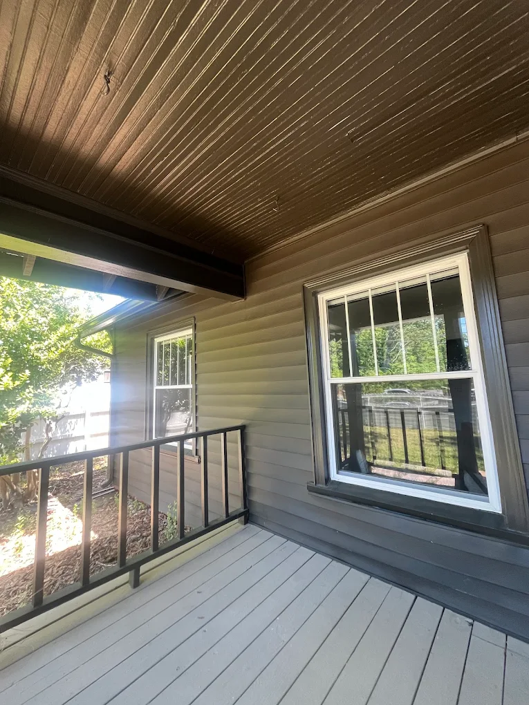Covered porch with siding and a wood-plank ceiling