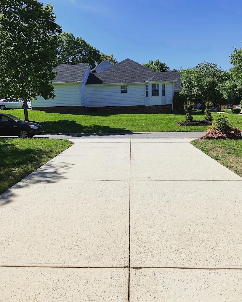 Freshly cleaned concrete driveway in front of a Concord, NC home